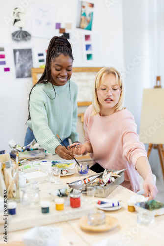 Young female artists working in their painting studio