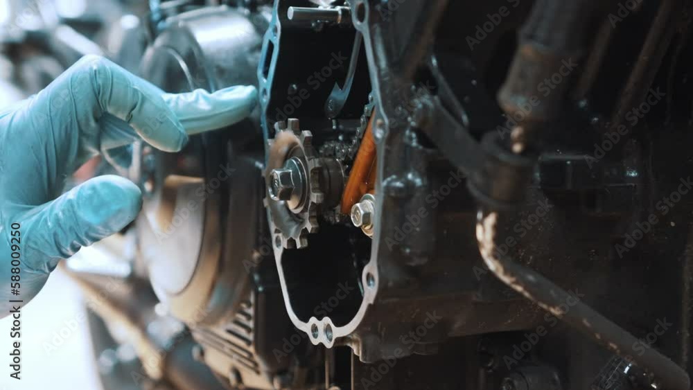 motorcycle gear box refurbishment. Close up on hand removing excess oil from the frame. High quality 4k footage motorcycle gear box refurbishment. Close up on hand removing excess oil from the frame. High quality 4k footage