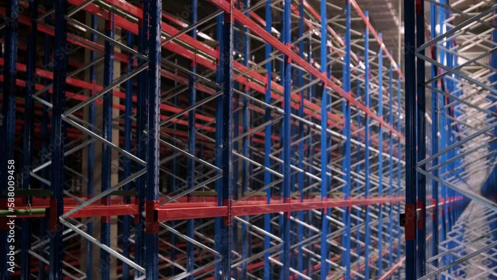 Big and modern warehouse under construction, featuring metal shelving and other industrial equipment. Big and modern warehouse under construction, featuring metal shelving and other industrial equipment.