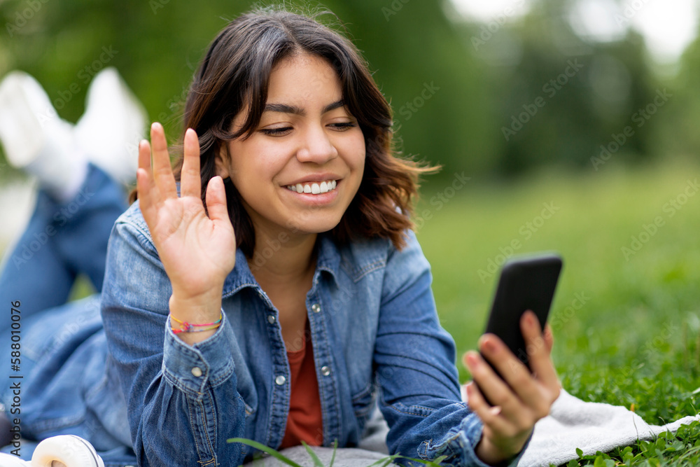 Cheerful Young Arab Woman Making Video Call On Smartphone Outdoors Cheerful Young Arab Woman Making Video Call On Smartphone Outdoors