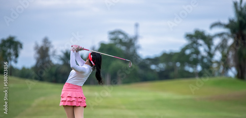 Professional woman golfer teeing golf in golf tournament competition at golf course for winner 