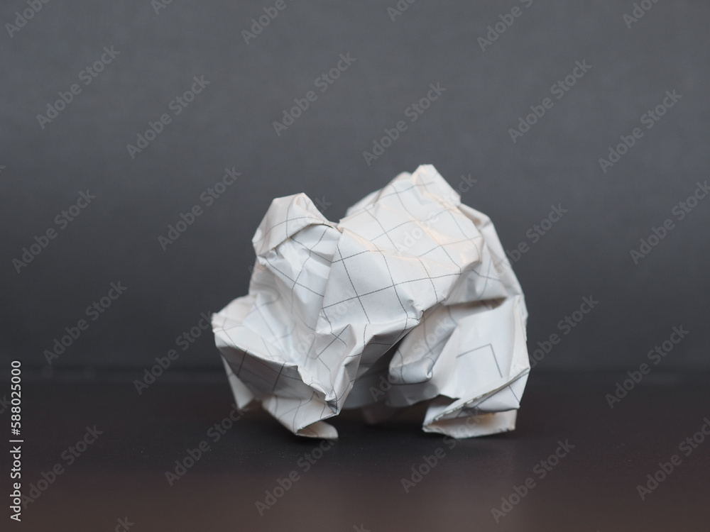 white paper ball over dark gray background white paper ball over dark gray background