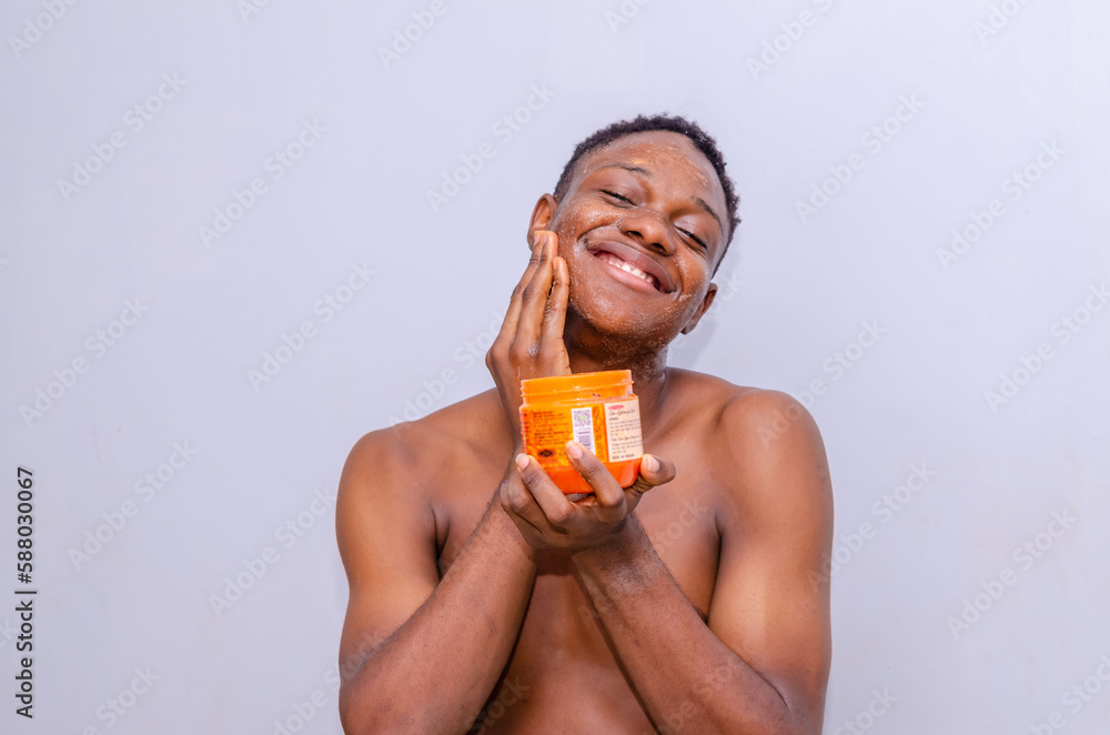 smiling Handsome african man applying face cream isolated on white background smiling Handsome african man applying face cream isolated on white background
