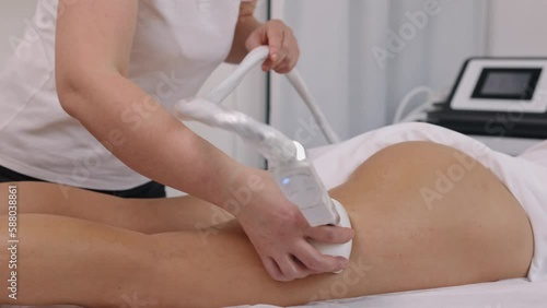 Endermologie, Correction cellulite, roller massage. Young woman from beauty salon performs beauty services, body shaping, masseurs perform vacuum roller massages for clients, figure correcting photo