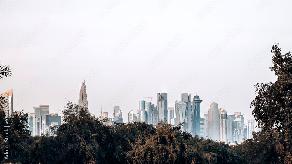 Fototapeta premium Panoramic view at Doha skyline with green trees and bushes