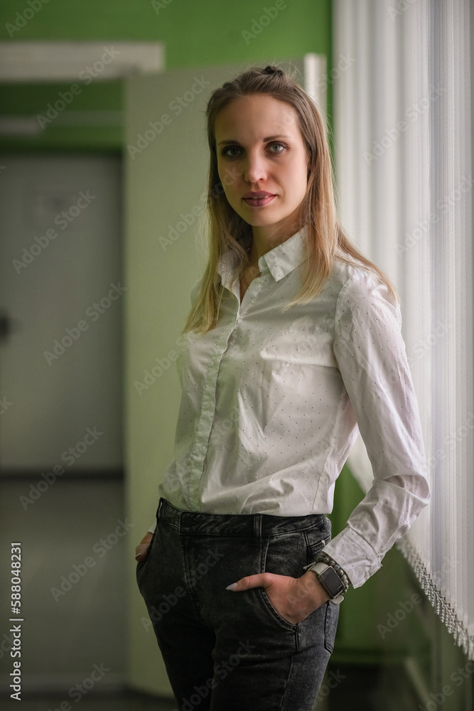 Portrait of a young beautiful long-haired girl in an interior studio with natural light. Portrait of a young beautiful long-haired girl in an interior studio with natural light.