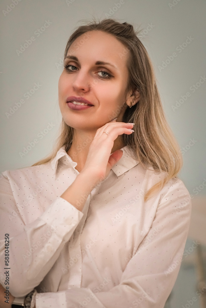Portrait of a young beautiful long-haired girl in an interior studio with natural light. Portrait of a young beautiful long-haired girl in an interior studio with natural light.