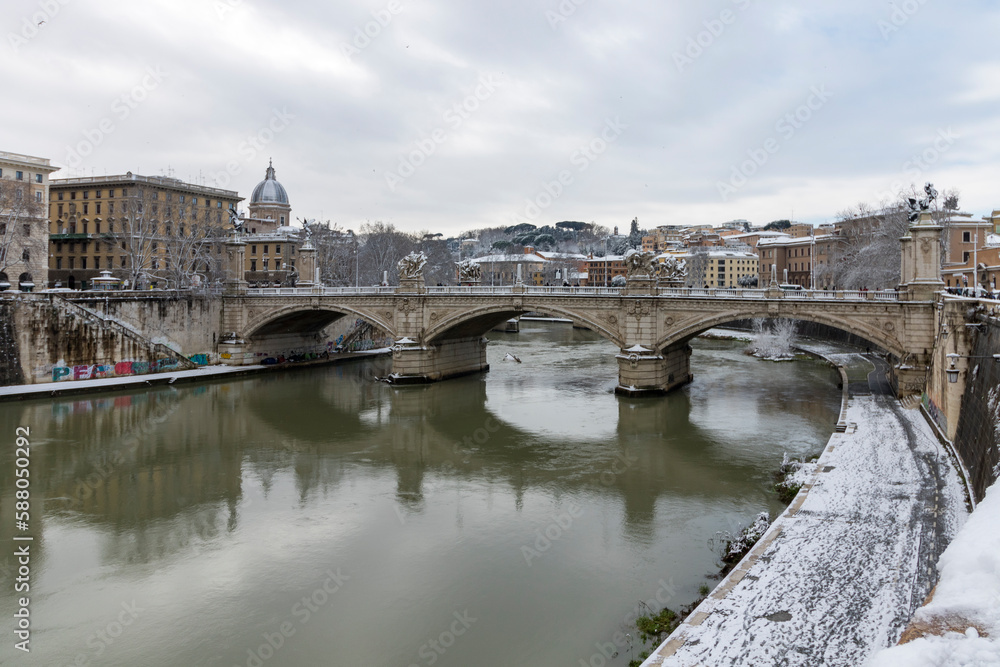 Rome under the snow. Vatican City in Italy on a snowy day. St. Peter's basilica in the background, St. Angel#s caste and bridge.