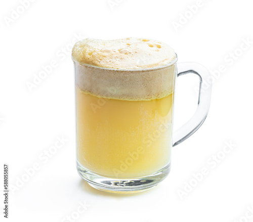 Homemade fresh squeezed fruit juice in a clear glass isolated on white