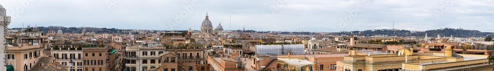 Rome as the capital of Italy seen from above. Panorama view of Roman city with St. Peter's Basilica, colosseum and Roman forums.