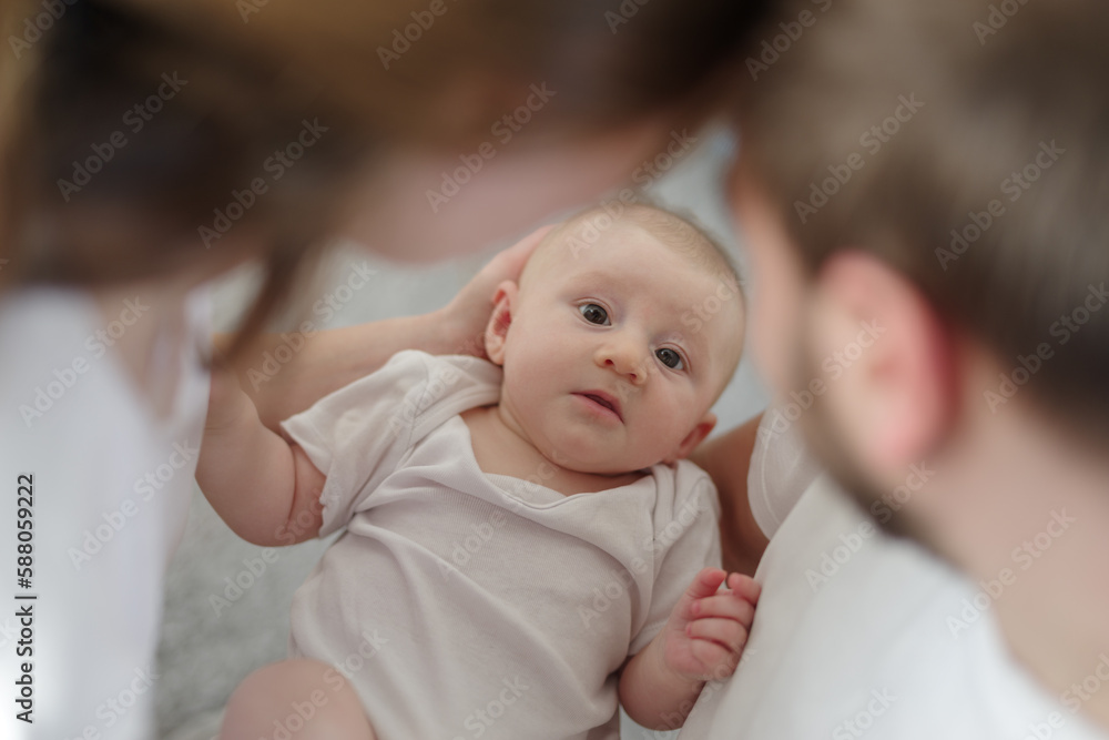 Mother and father holding a newborn baby son at home Mother and father holding a newborn baby son at home
