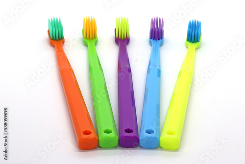 Multicolored toothbrushes on a white background