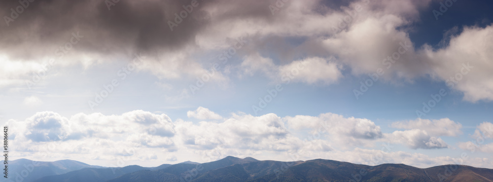 gorgeous panorama of a blue sky with fluffy clouds. amazing cloudscape above the mountain range on a sunny weather in summer