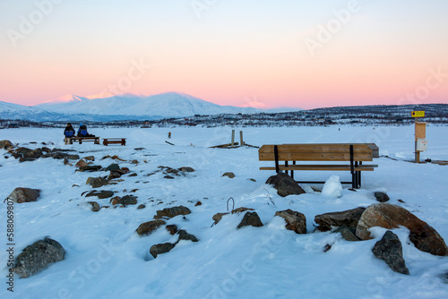 Abisko in Lapland in Sweden. Sunset at frozen Tornetrask Lake. Sun, snow, ice, the Arctic Circle, a landscape of northern Europe