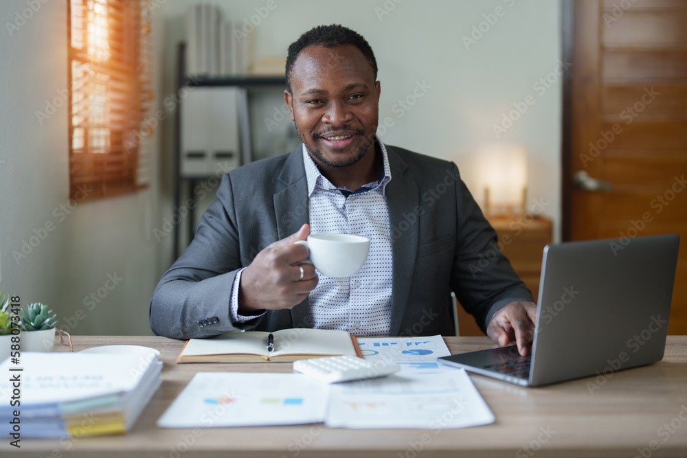 middle aged man American African using computer laptop with planning working on financial document, tax, exchange, accounting and Financial advisor middle aged man American African using computer laptop with planning working on financial document, tax, exchange, accounting and Financial advisor