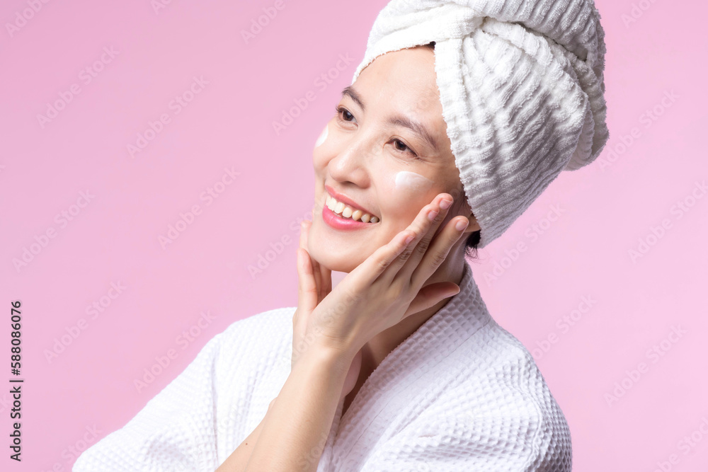Young asian woman applying facial skincare face cream, cosmetic moisturiser on healthy natural skin make up face. Portrait glowing smile girl person model with care beauty product, spa, cosmetology. Young asian woman applying facial skincare face cream, cosmetic moisturiser on healthy natural skin make up face. Portrait glowing smile girl person model with care beauty product, spa, cosmetology.
