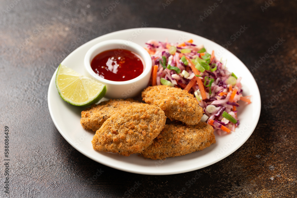 Vegetarian vegan southern fried nuggets served with sweet chilli sauce and cabbage salad Vegetarian vegan southern fried nuggets served with sweet chilli sauce and cabbage salad