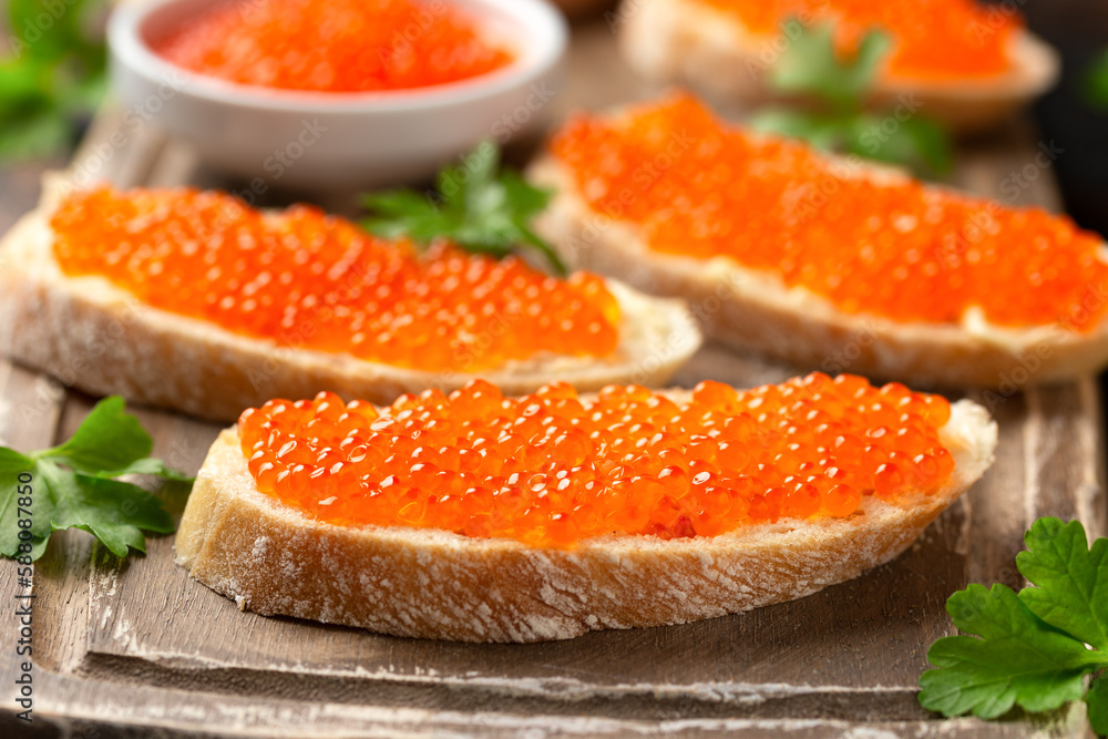 Salmon red caviar sandwiches on wooden board Salmon red caviar sandwiches on wooden board
