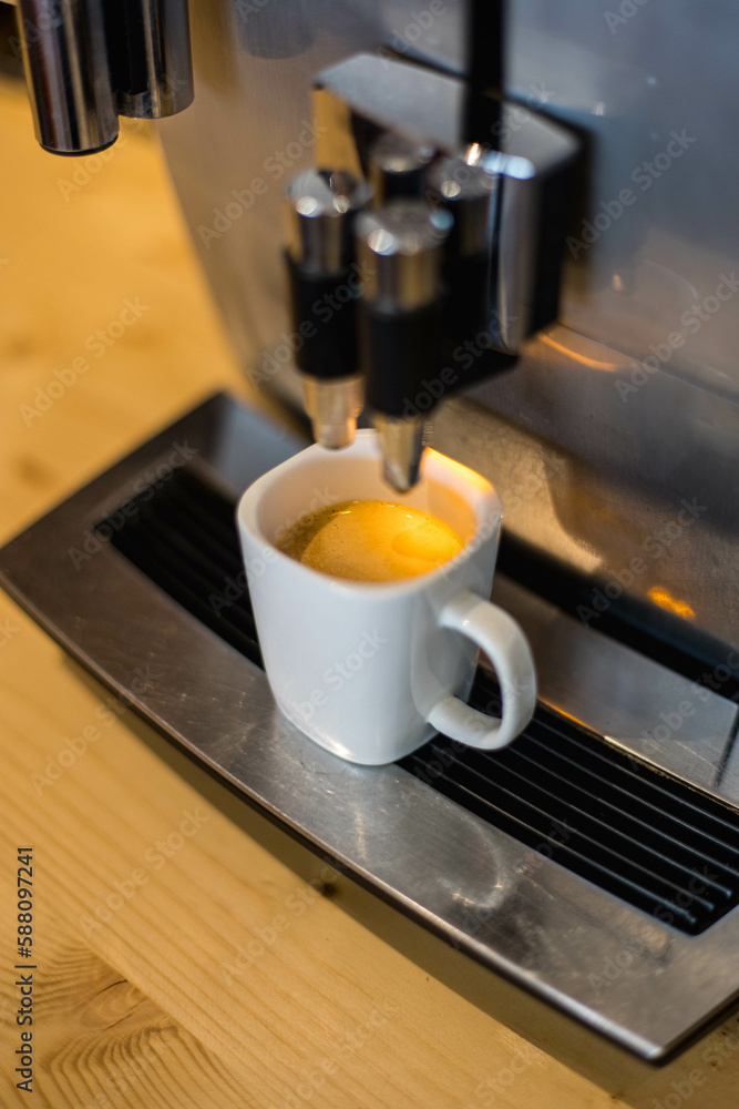 Une machine à café à grain, avec un expresso frais dans une tasse - obrazy, fototapety, plakaty 