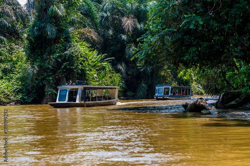 A view of boats on the Tortuguero River in Costa Rica during the dry season photo