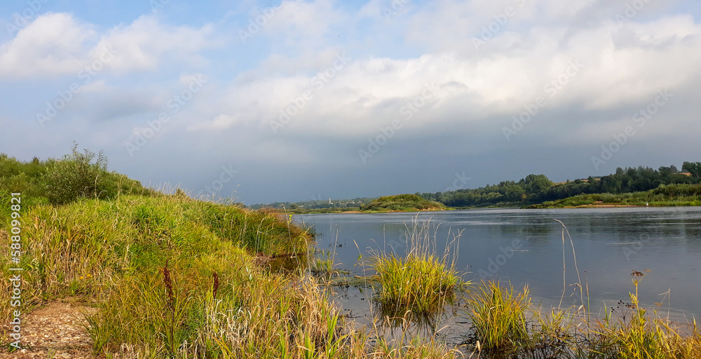 River landscape. Stormy sky over the Daugava river in Latvia in summer