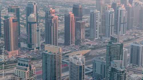 JLT skyscrapers near Sheikh Zayed Road aerial timelapse. Residential buildings and villas behind