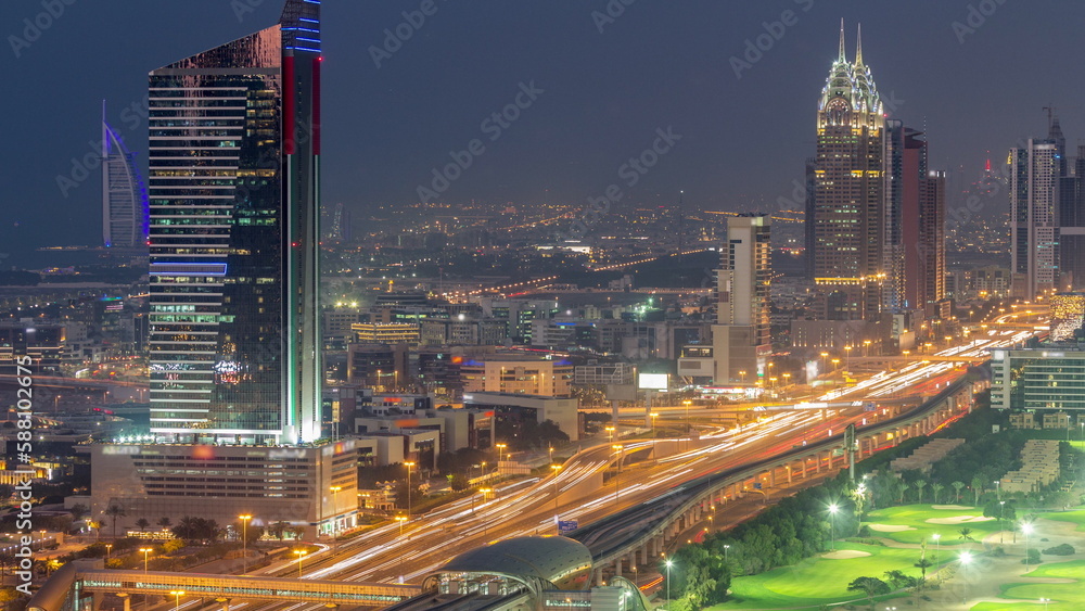 Fototapeta premium Aerial view of Sheikh Zayed Road in Dubai Internet City area day to night timelapse