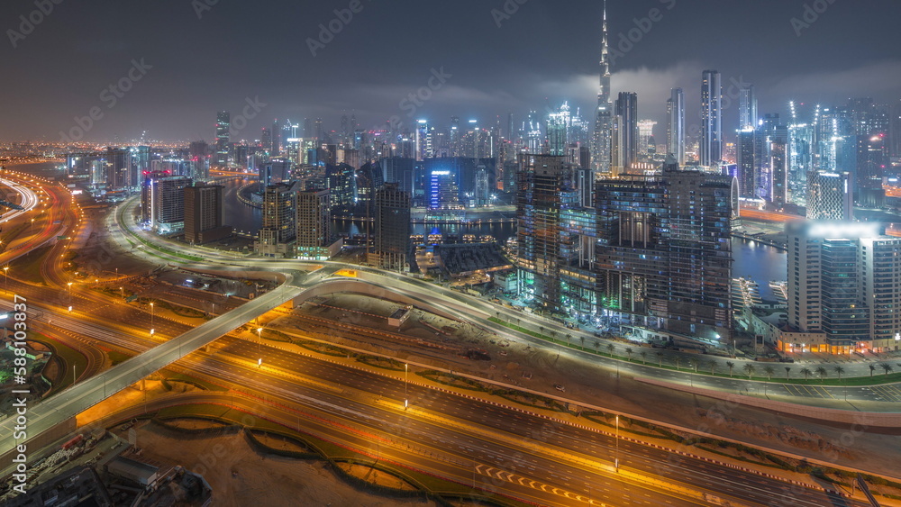 Obraz premium Panoramic skyline of Dubai with business bay and downtown district all night timelapse.