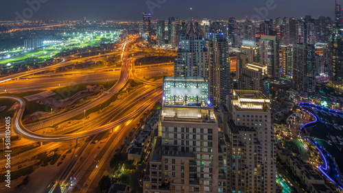 Dubai marina and JLT skyscrapers along Sheikh Zayed Road aerial day to night timelapse.