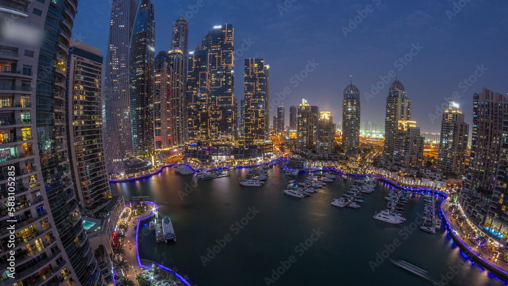 Dubai marina tallest skyscrapers and yachts in harbor aerial day to night timelapse. Dubai marina tallest skyscrapers and yachts in harbor aerial day to night timelapse.