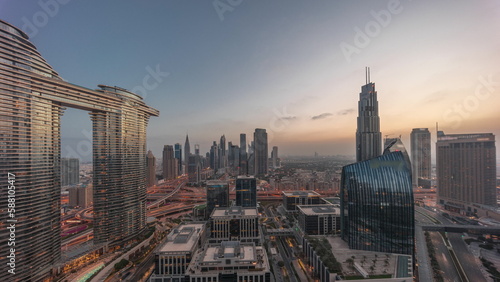 Futuristic Dubai Downtown and finansial district skyline aerial night to day timelapse.