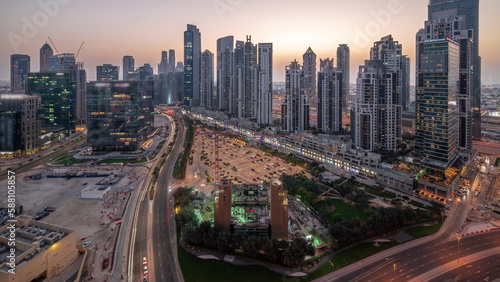 Bay Avenue with modern towers residential development in Business Bay aerial panoramic day to night timelapse, Dubai