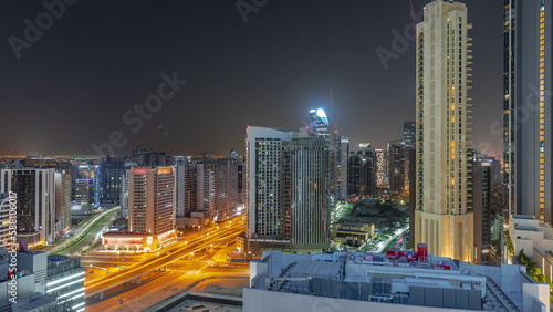 Skyscrapers at the Business Bay in Dubai aerial all night timelapse, United Arab Emirates