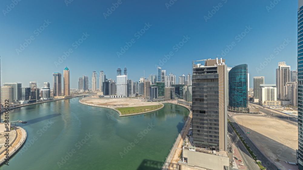 Fototapeta premium Cityscape skyscrapers of Dubai Business Bay with water canal aerial timelapse.
