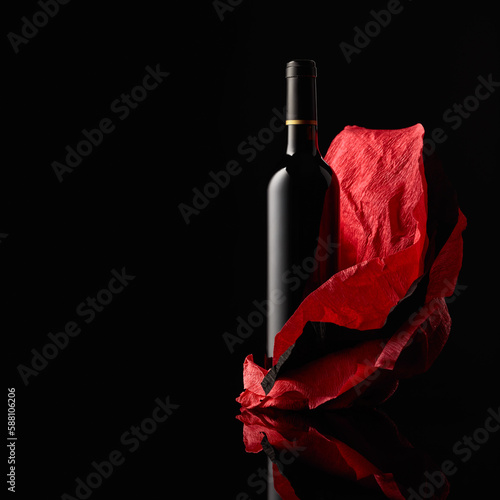 Bottle of red wine on a crumpled paper.