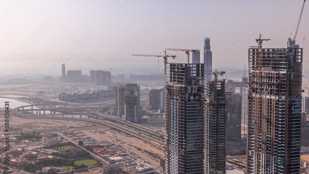 Dubai downtown with large-scale construction of a residential complex with a view of construction cranes aerial timelapse