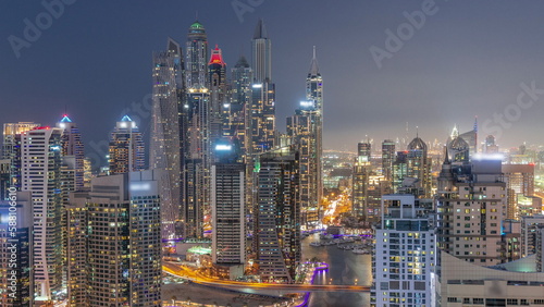 View of various skyscrapers in tallest recidential block in Dubai Marina aerial day to night timelapse