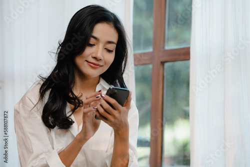 Smiling girl use a mobile p...