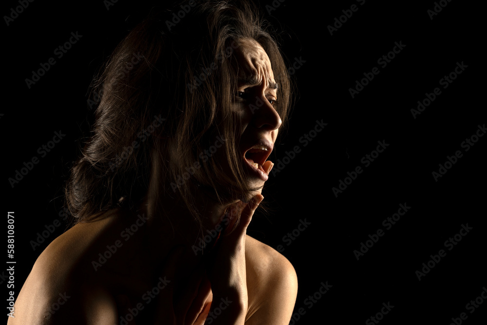 Silhouette of young unhappy crying woman on black background Silhouette of young unhappy crying woman on black background