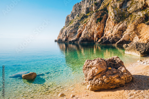 Calm lagoon and wild beach with azure water on a sunny day. Island Cres, Croatian coast, Europe.