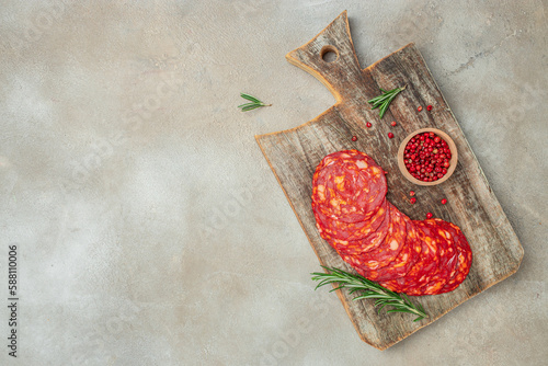 Spanish traditional chorizo sausage on a wooden board. banner, menu, recipe place for text, top view photo