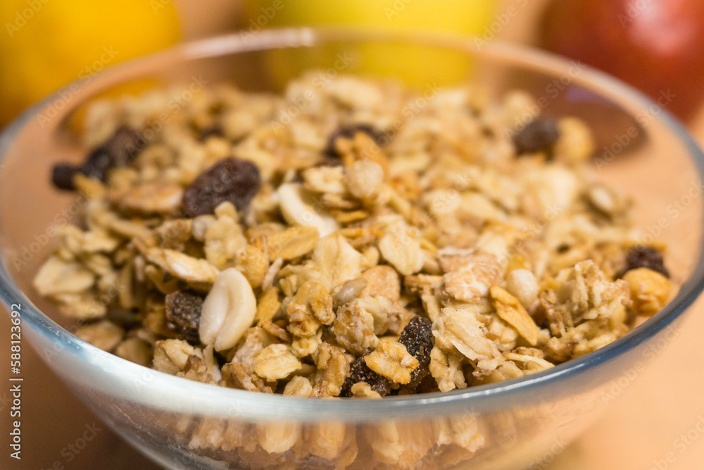 muesli in a glass plate in the background red pear, yellow block, lemon muesli in a glass plate in the background red pear, yellow block, lemon