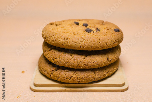oatmeal cookies with chocolate on orange background