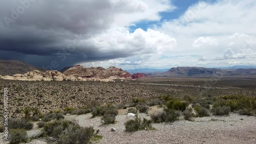 Canyon view with one stormy sky and one bright sky in the desert of Nevada - Red Rock Canyon, March 2023