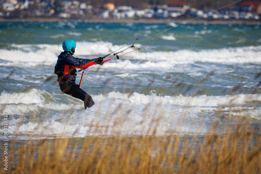 one kitesurfer surfing in stormy weather on the baltic sea