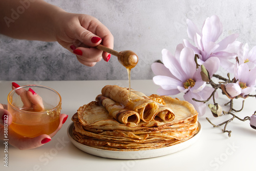 Obraz na plátně Stack of fresh crepes with honey and raspberries on the table copy space