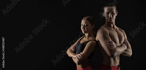 sport couple of fitness trainers in studio. advertisement banner with sport couple, copy space.