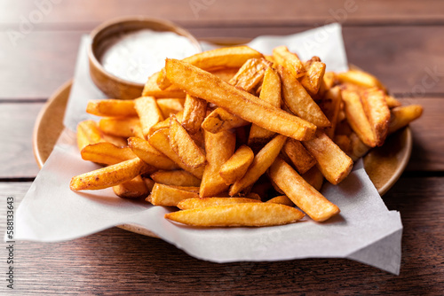 French fries, pommes frites on a plate with mayonaise, salty snack