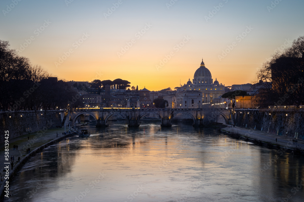 ityscape with Sant Angelo bridge and St. Peter's cathedral at nightfall with city lights in Rome, Italy