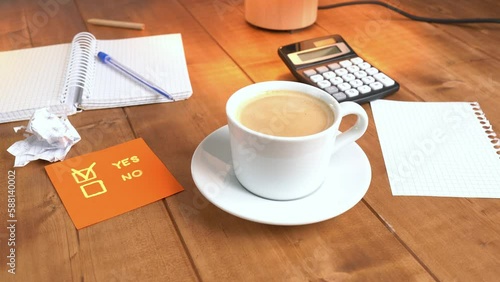 A man serves coffee on a wooden table.